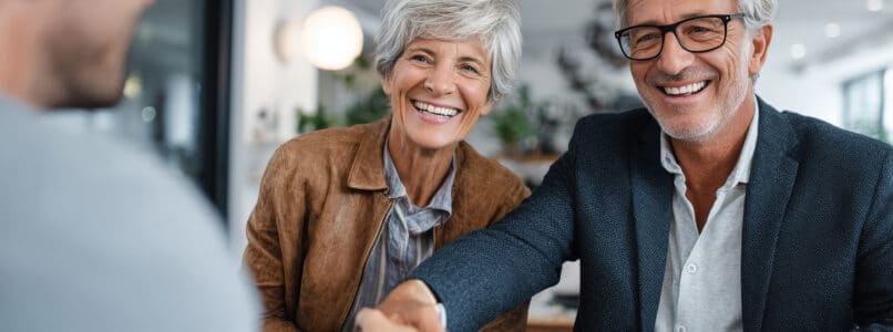 Man and his wife meeting with a financial advisor to review tax planning